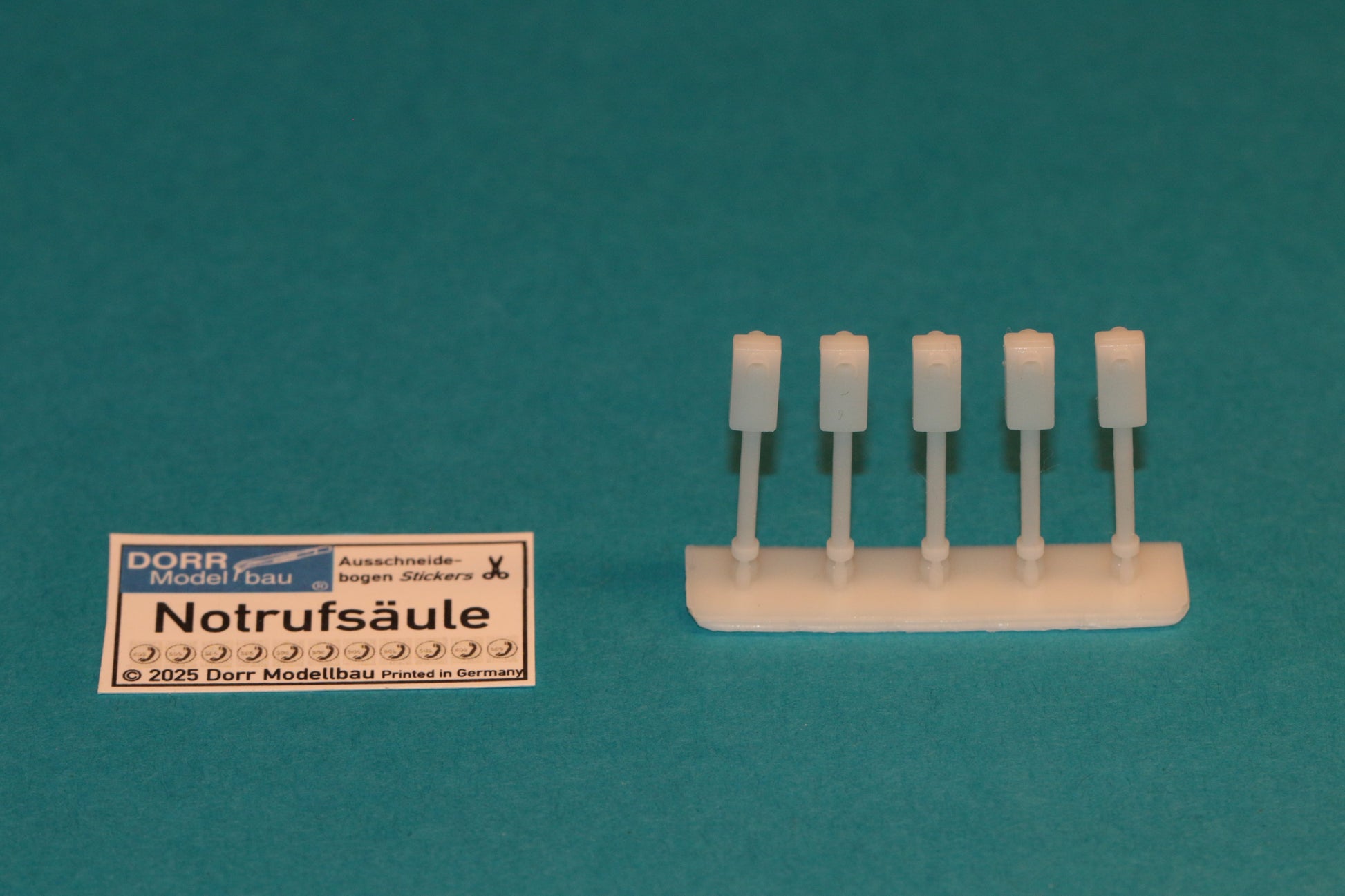 Das Set von DorrModellbau umfasst 5 detaillierte Notrufsäulen im Maßstab H0 1:87 sowie die zugehörigen Aufkleber